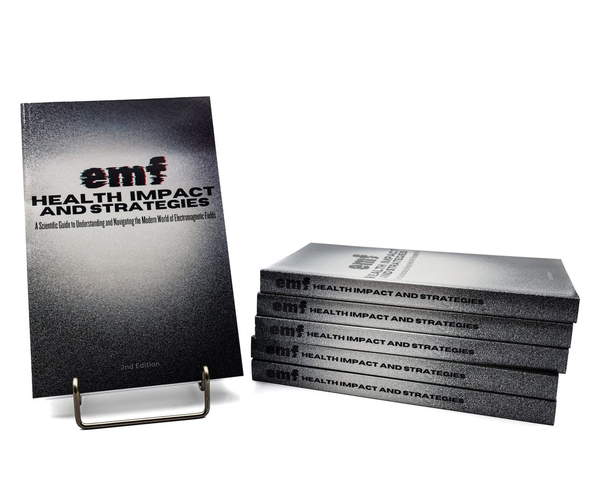 EMF Health Impact and Strategies book on a stand beside a stack of copies