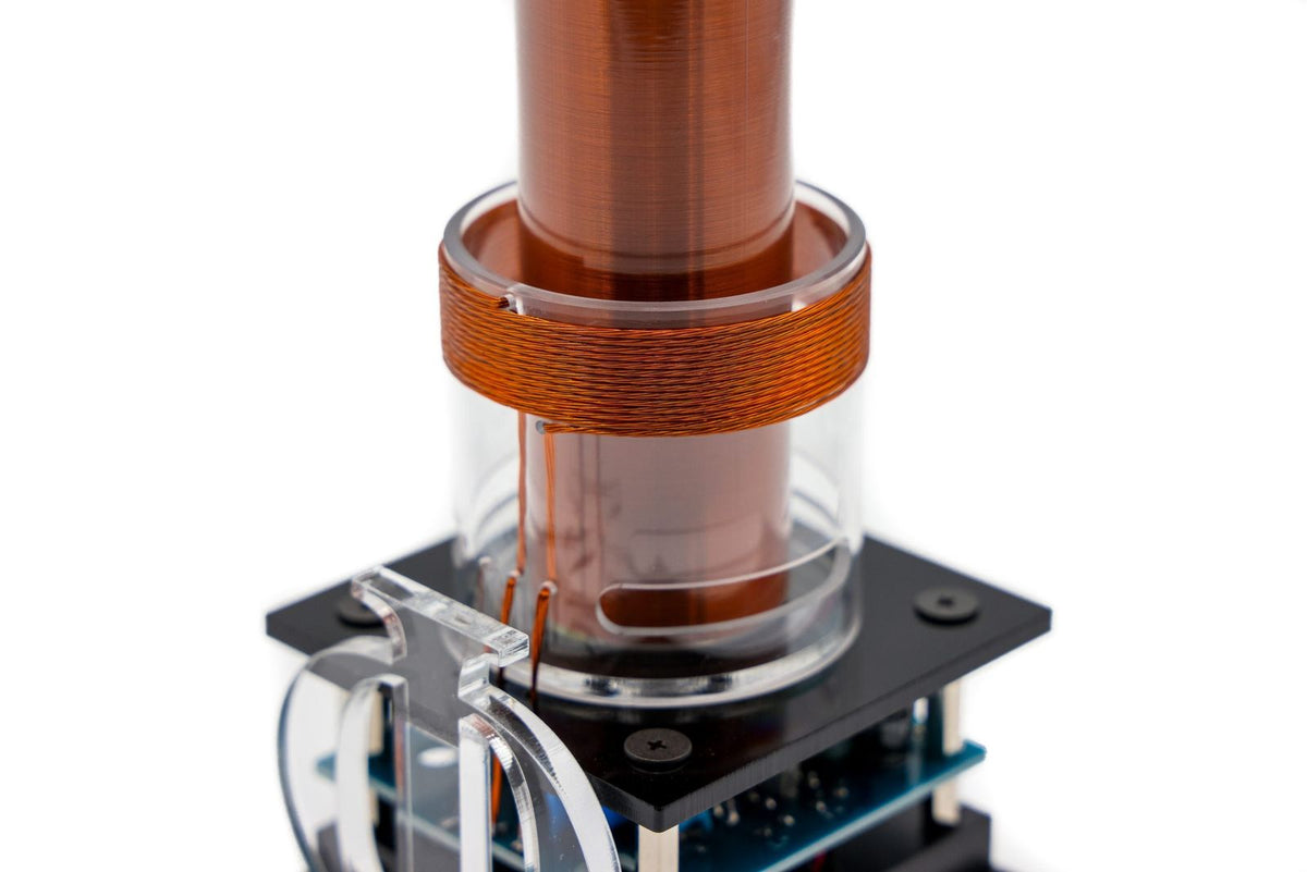 Close-up of a quantaphi coil with copper coils and glass container on a white background