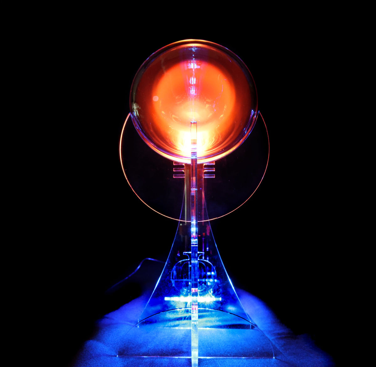 quantaphi tube  with glowing red and blue lights on a black background