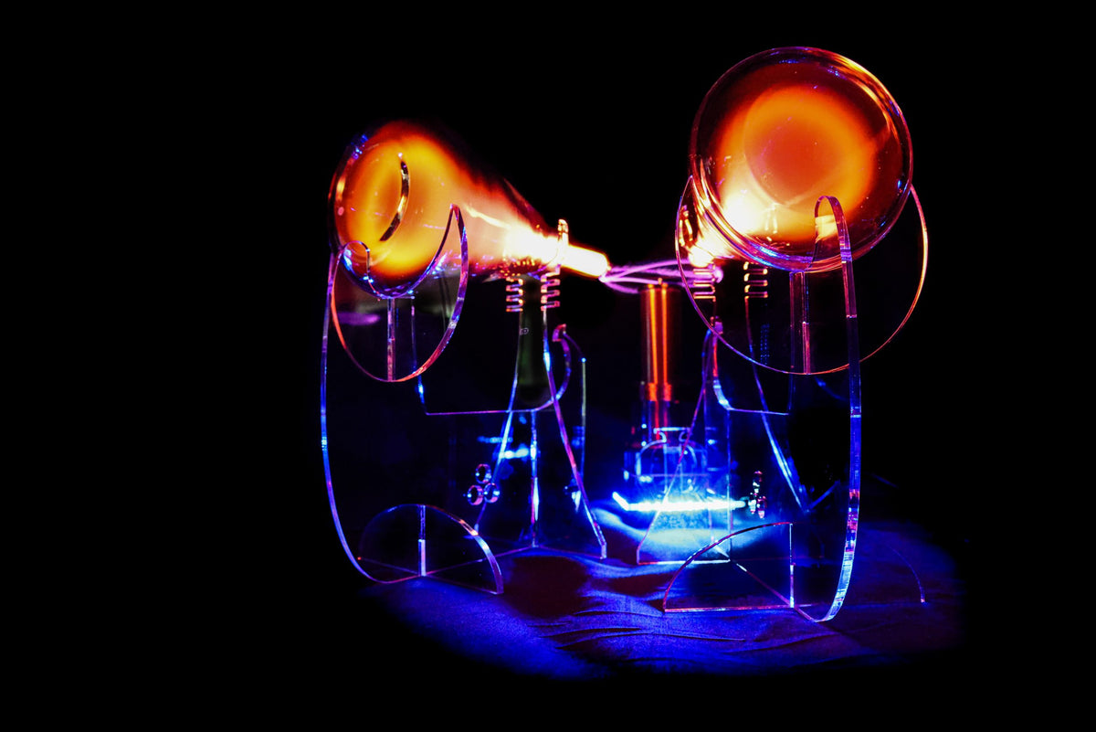 Glass quantaphi tubes with glowing orange and blue lights on a black background