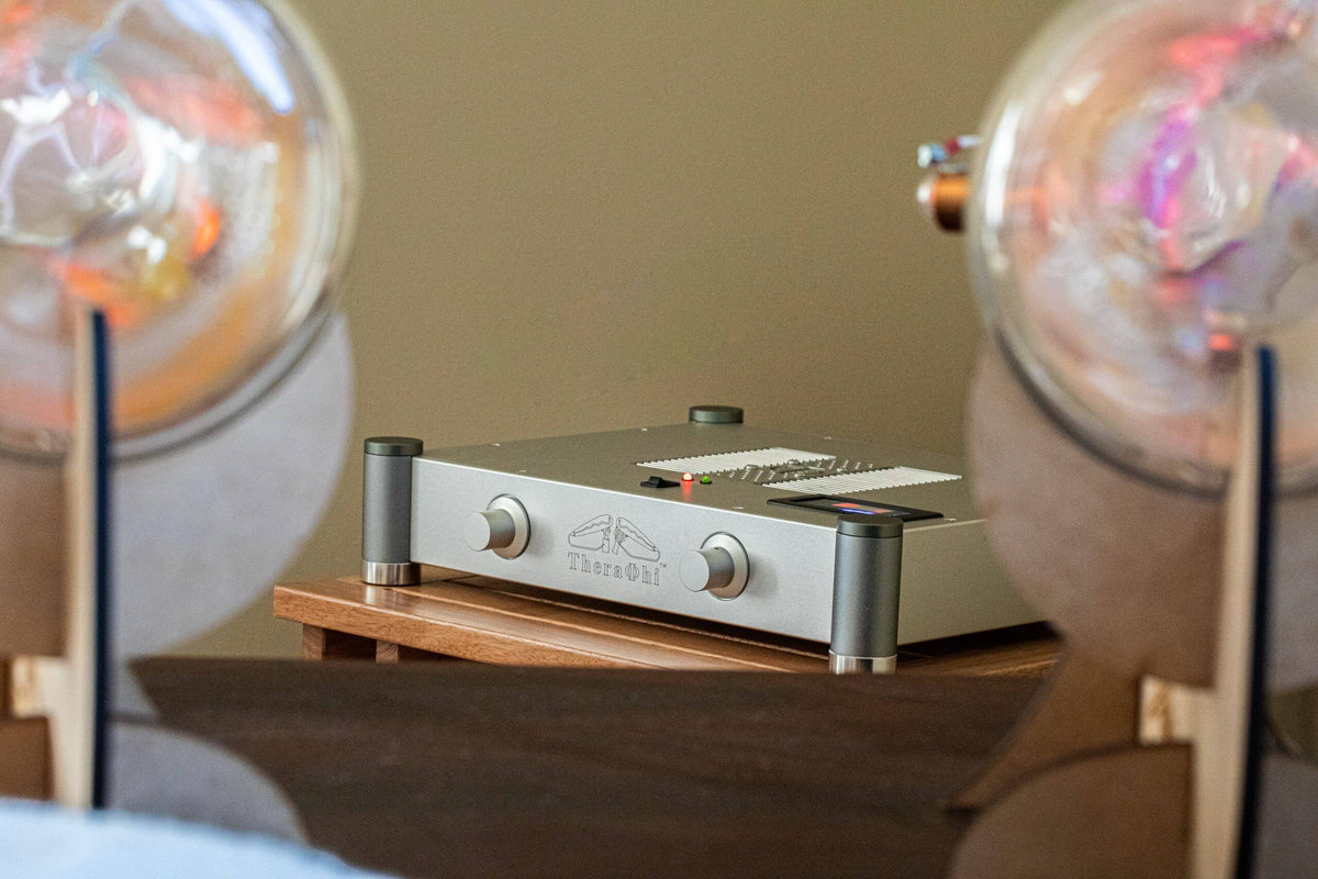 Theraphi amplifier on a table with two blurred Theraphi bulbs in the foreground