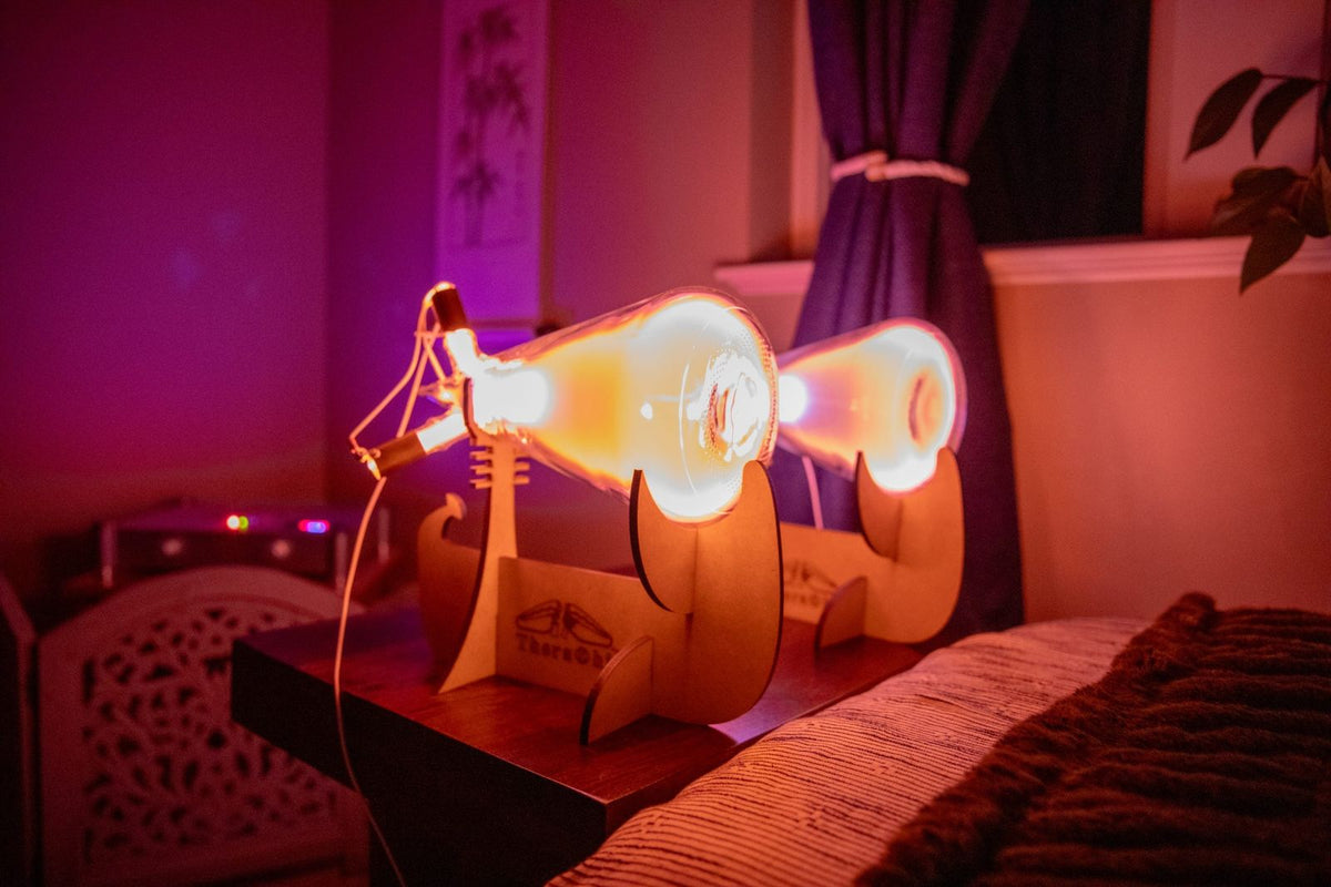 Theraphi tubes at the end of a bed in a dimly lit room