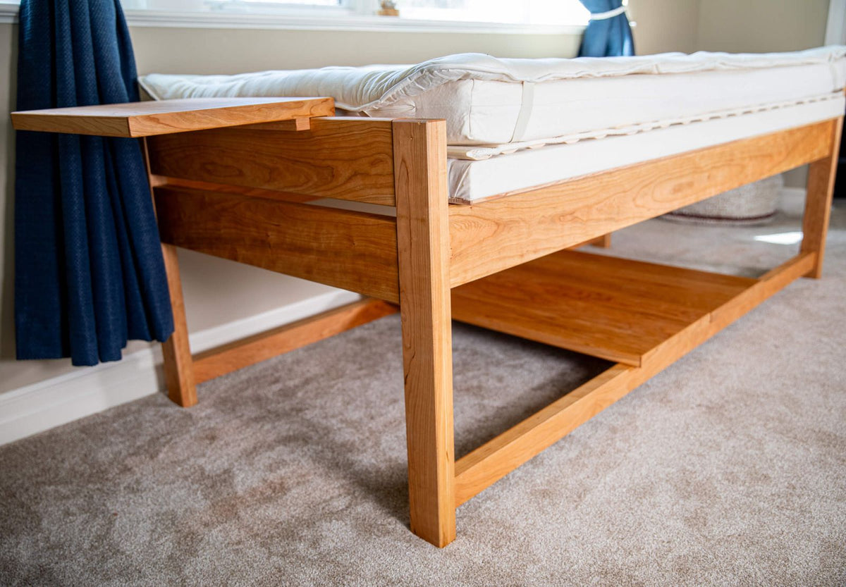 side shot of theraphi bed in front of a window
